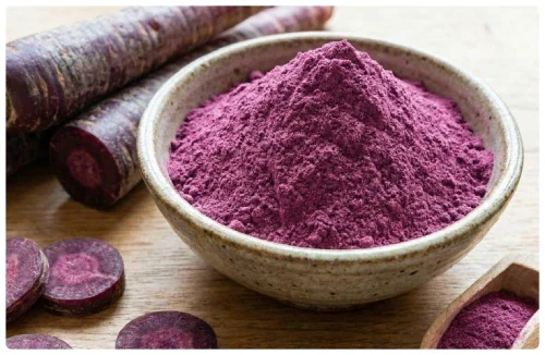 Bowl of purple carrot powder beside sliced purple carrots, an anthocyanin source in DentaBiome